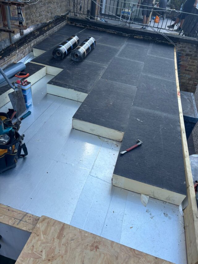 Vapour control barrier and premium rigid insulation being expertly installed on a residential flat roof by our dedicated flat roofer London contractors in Shepherds Bush.