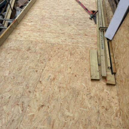 Heavy-duty structural OSB flat roof decking securely fastened by our accredited roofer London professionals for a residential property upgrade in West London.