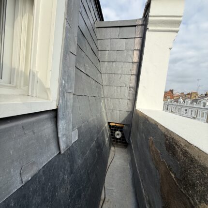 Lead-lined valley gutter, parapet flashing, and natural slate courses completed by our roofer in Mayfair W1K.